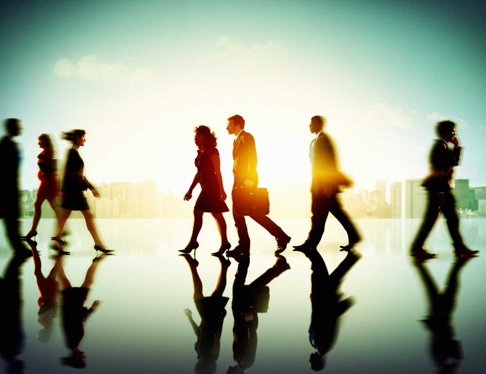 group of executives walking in open building
