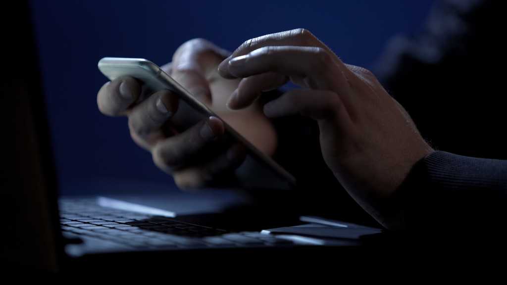 person using a smartphone in a dark room