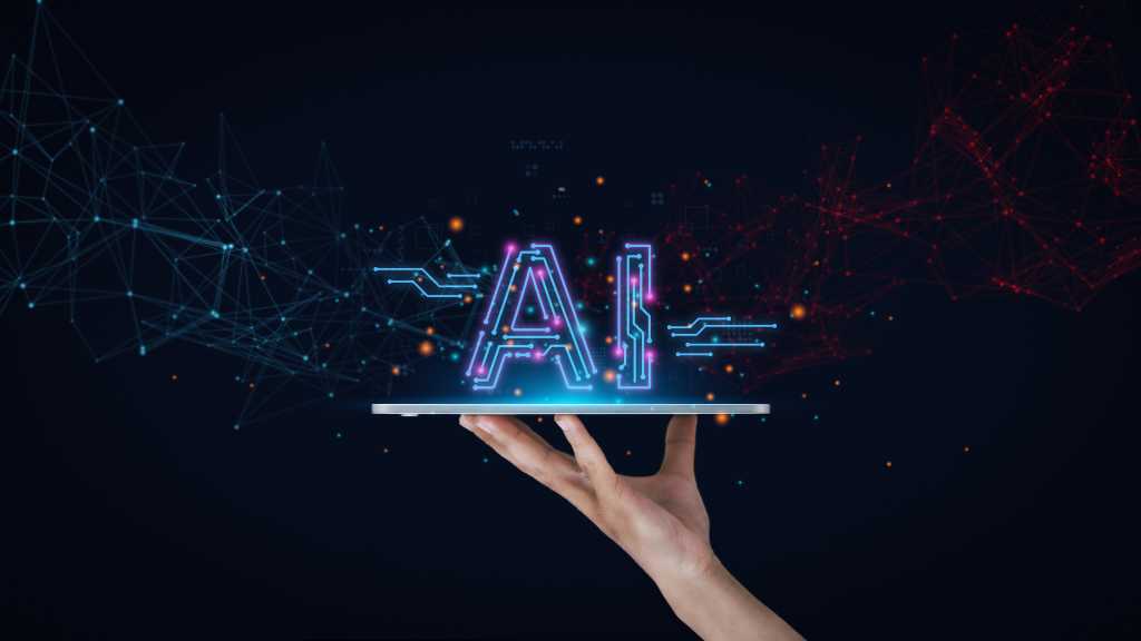 A human hand against a midnight-black background holds a tablet like a platter with the word "AI" resting on top. AI tools, AI technology, AI innovation.