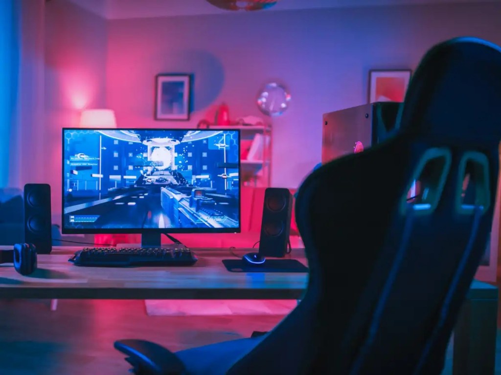 Gaming-PC-rig-with-RGB-workstation-and-empty-gaming-chair